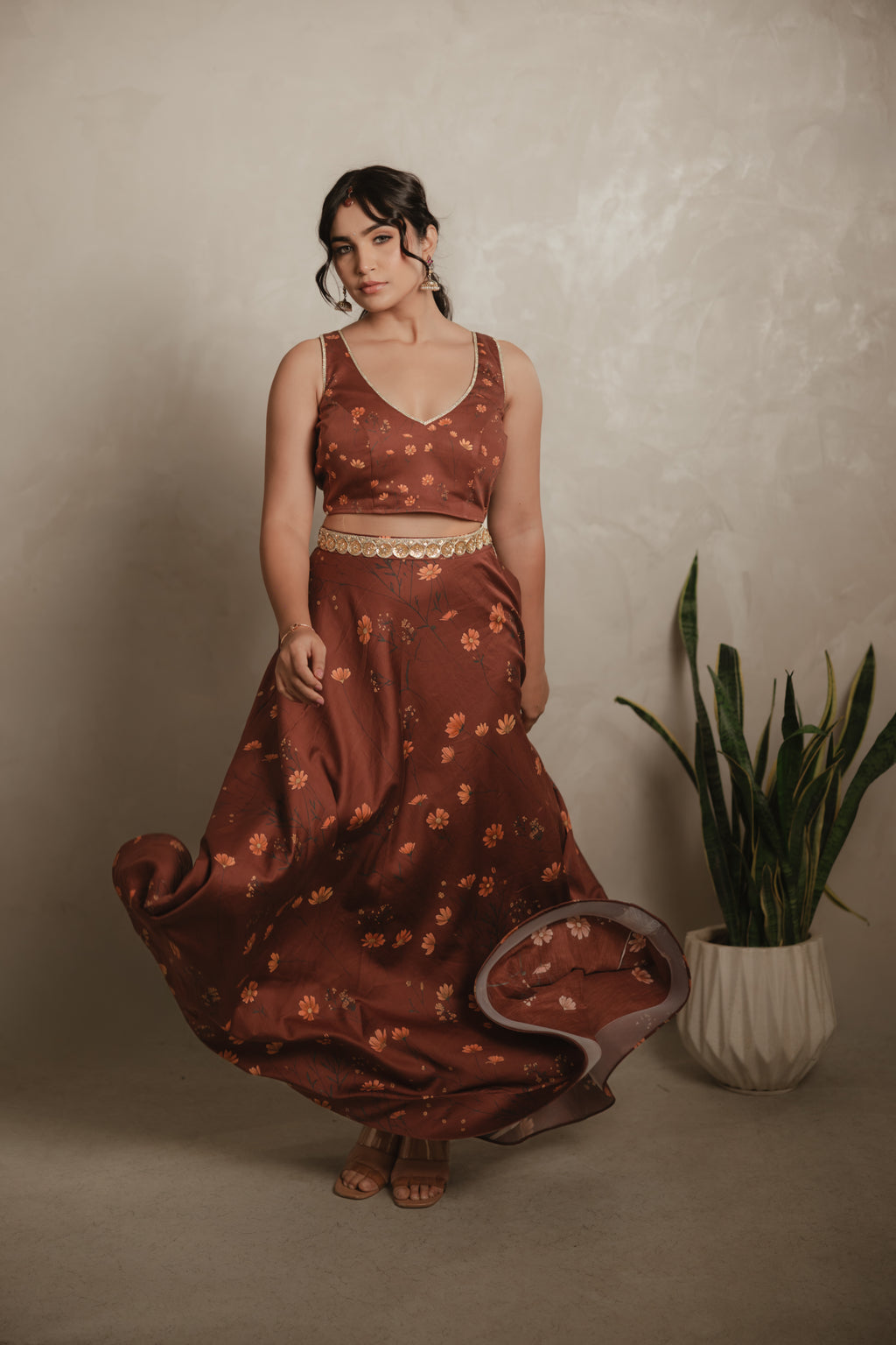 Sthira Celosia co-ord set in vegan silk, rust-brown botanical print, front view, in movement