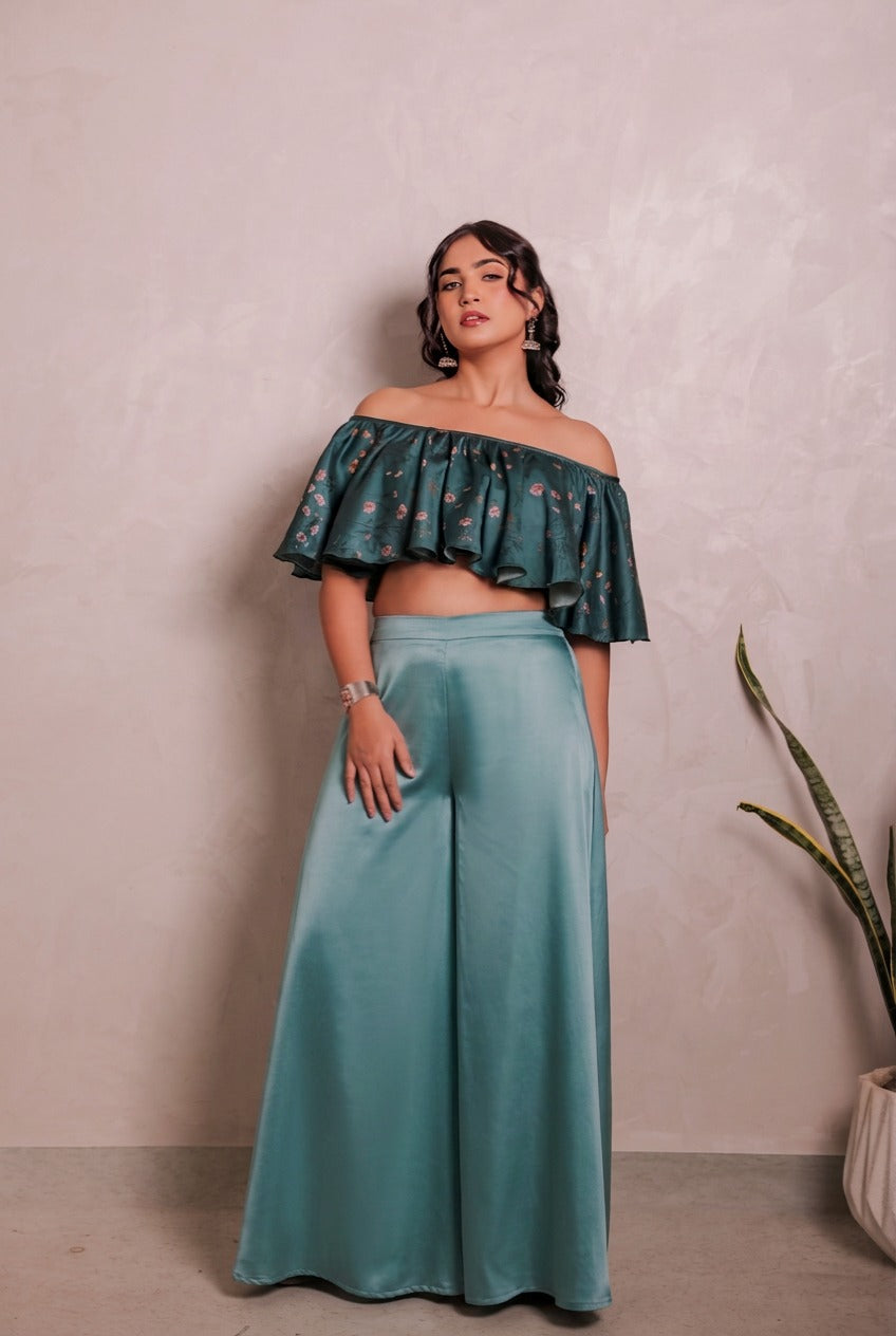 Sthira Bluebell ruffled off-shoulder blouse in deep teal vegan silk with solid wide-leg trousers