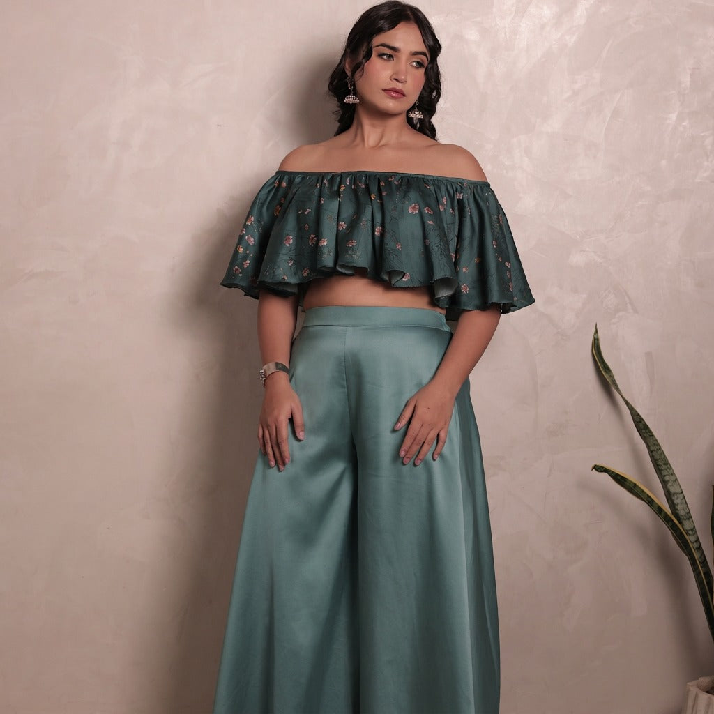 Sthira Bluebell ruffled off-shoulder blouse in deep teal vegan silk with solid wide-leg trousers