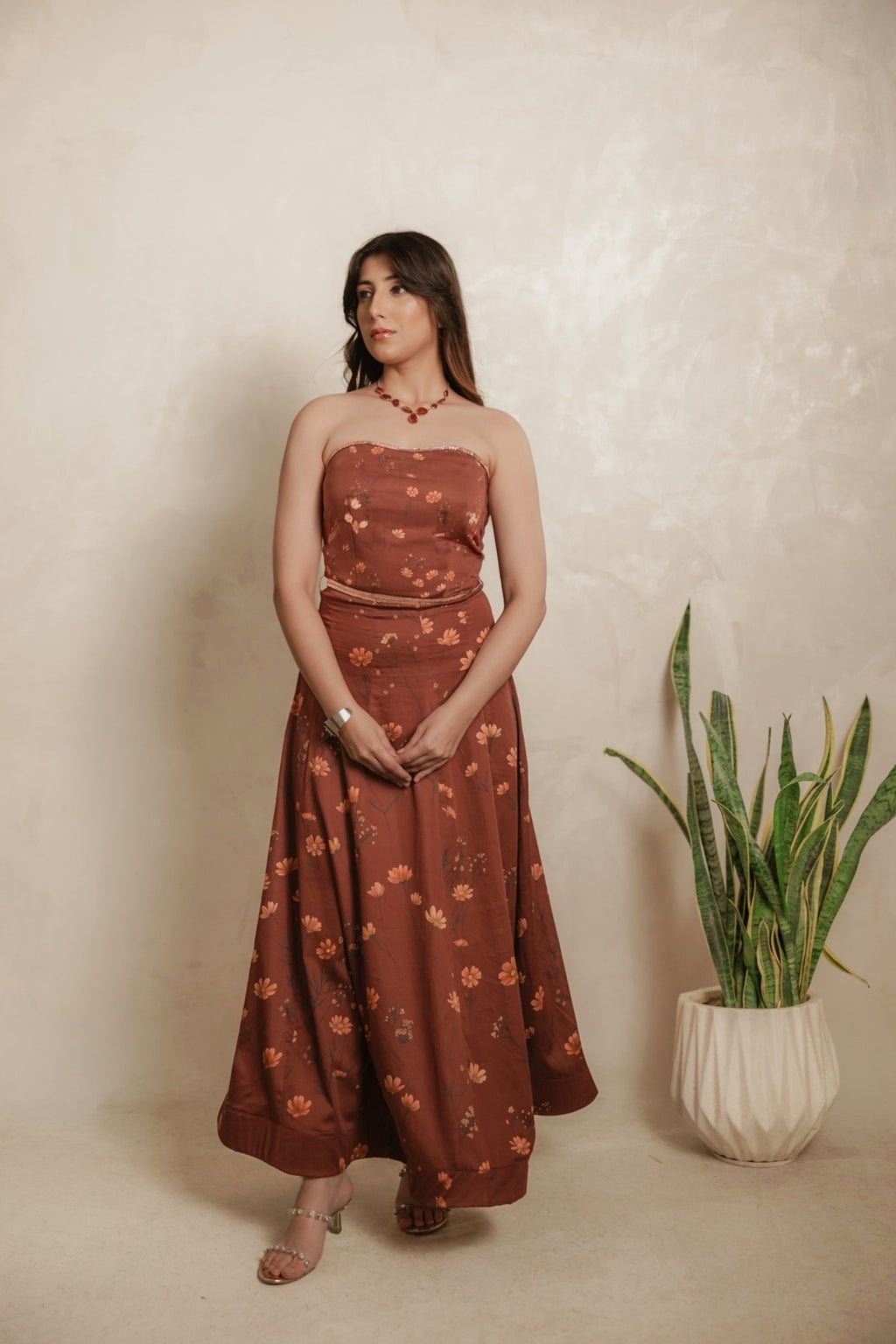 Sthira Calendula gown in warm rust-brown vegan silk with apricot blooms, worn with the sheer rust cape dupatta