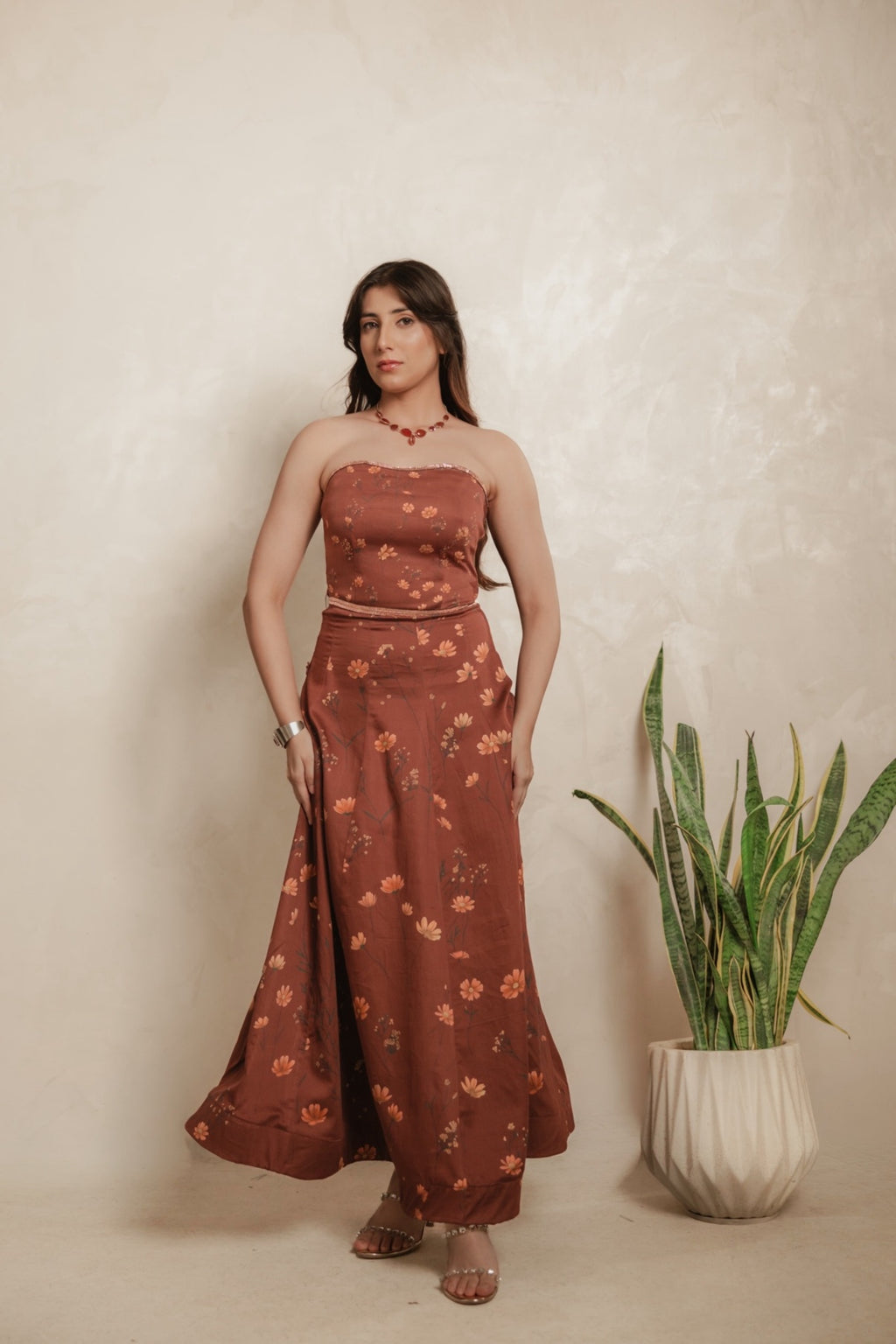 Sthira Calendula gown in warm rust-brown vegan silk with apricot blooms, worn with the sheer rust cape dupatta